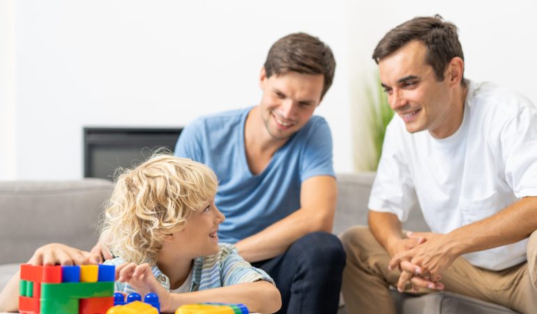 Lgbt family, gay couple with adopted son - Homosexual parents with their kid having fun at home
