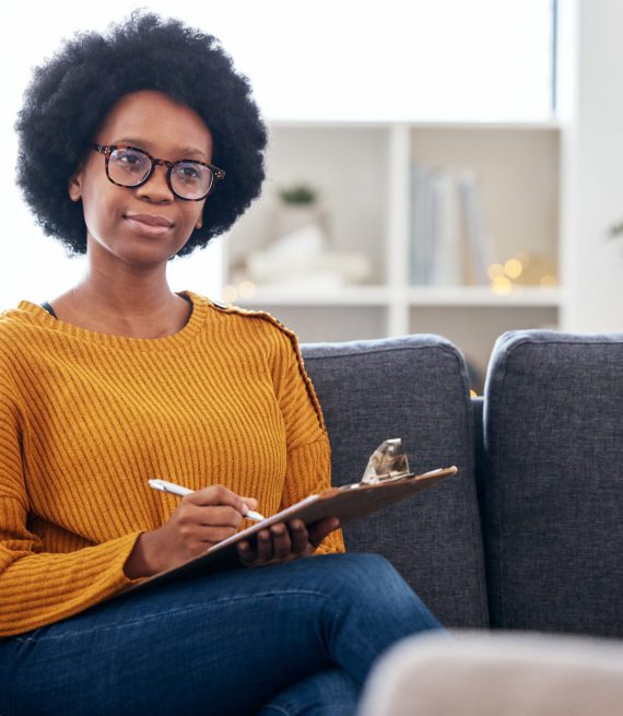 Psychologist on sofa, writing notes and listening to patient, advice and help in psychology for men.